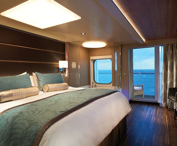 The Haven's Deluxe Suite with Balcony bedroom on Norwegian Escape